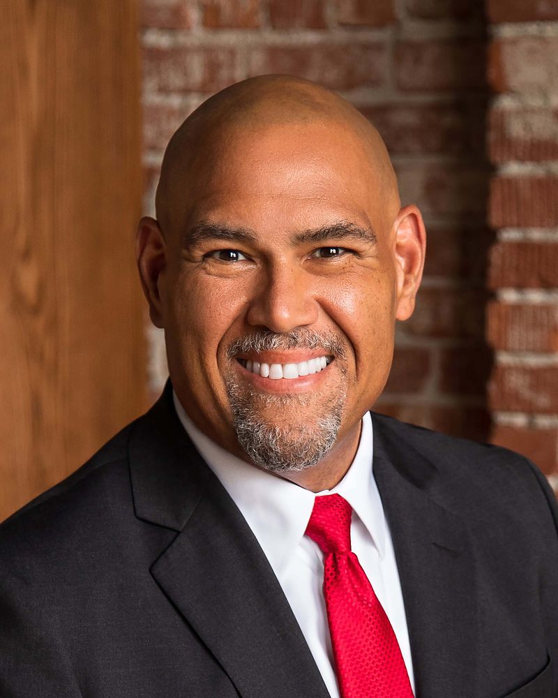 Professional business portrait of a smiling man in a shirt and tie