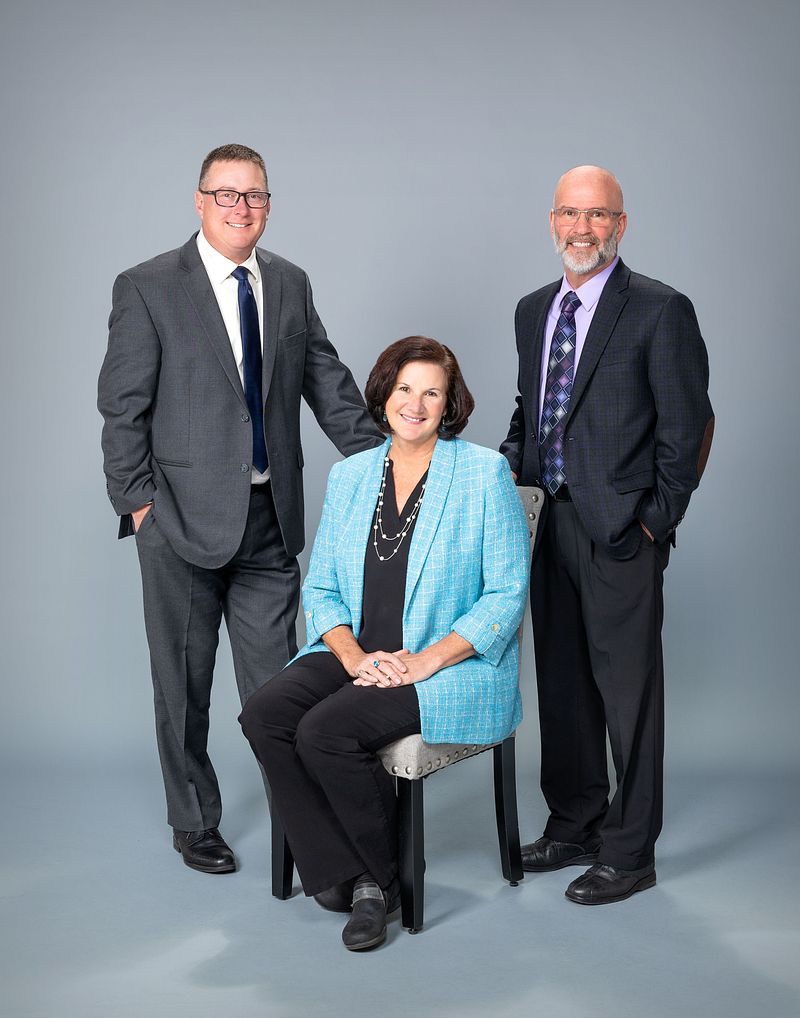 Group portrait of three colleagues in business attire