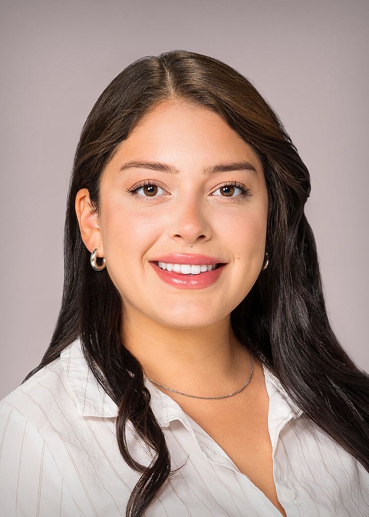Business headshot of a woman in a white blouse