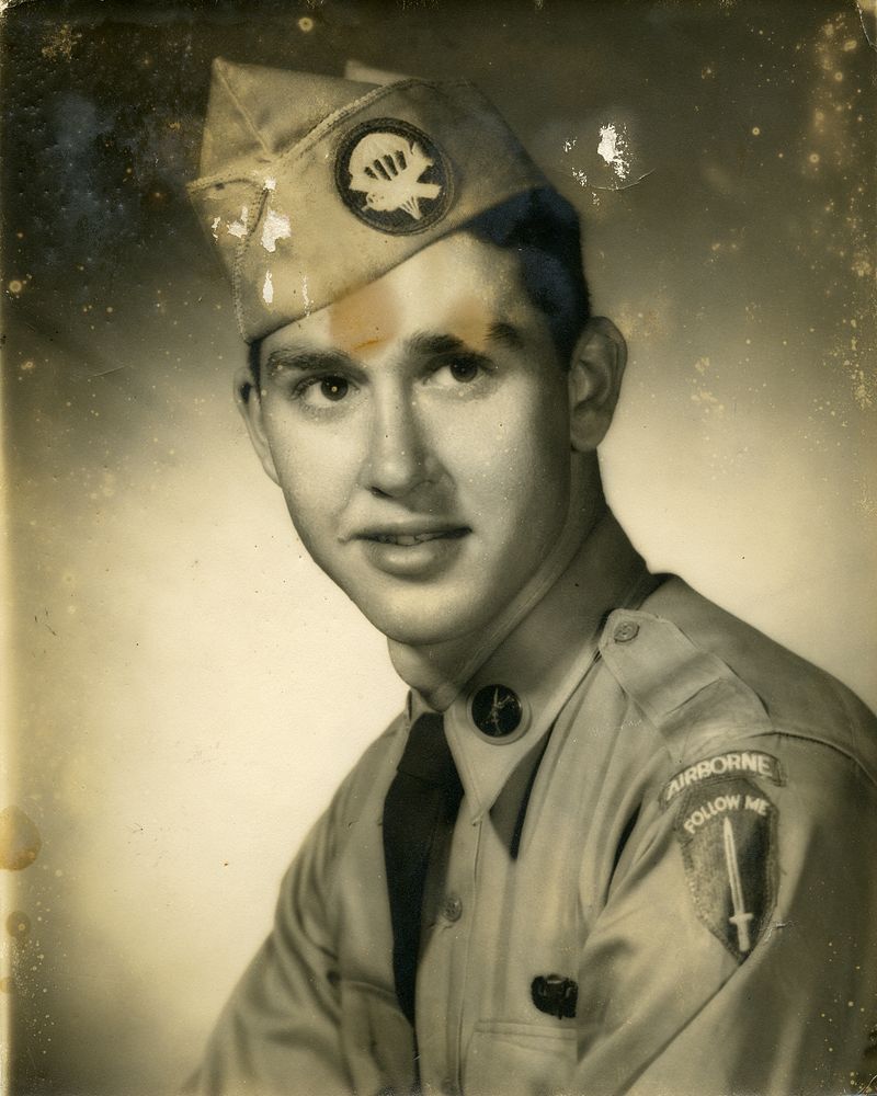 Old portrait of a young Airborne soldier, faded, spotted and stained, before restoration
